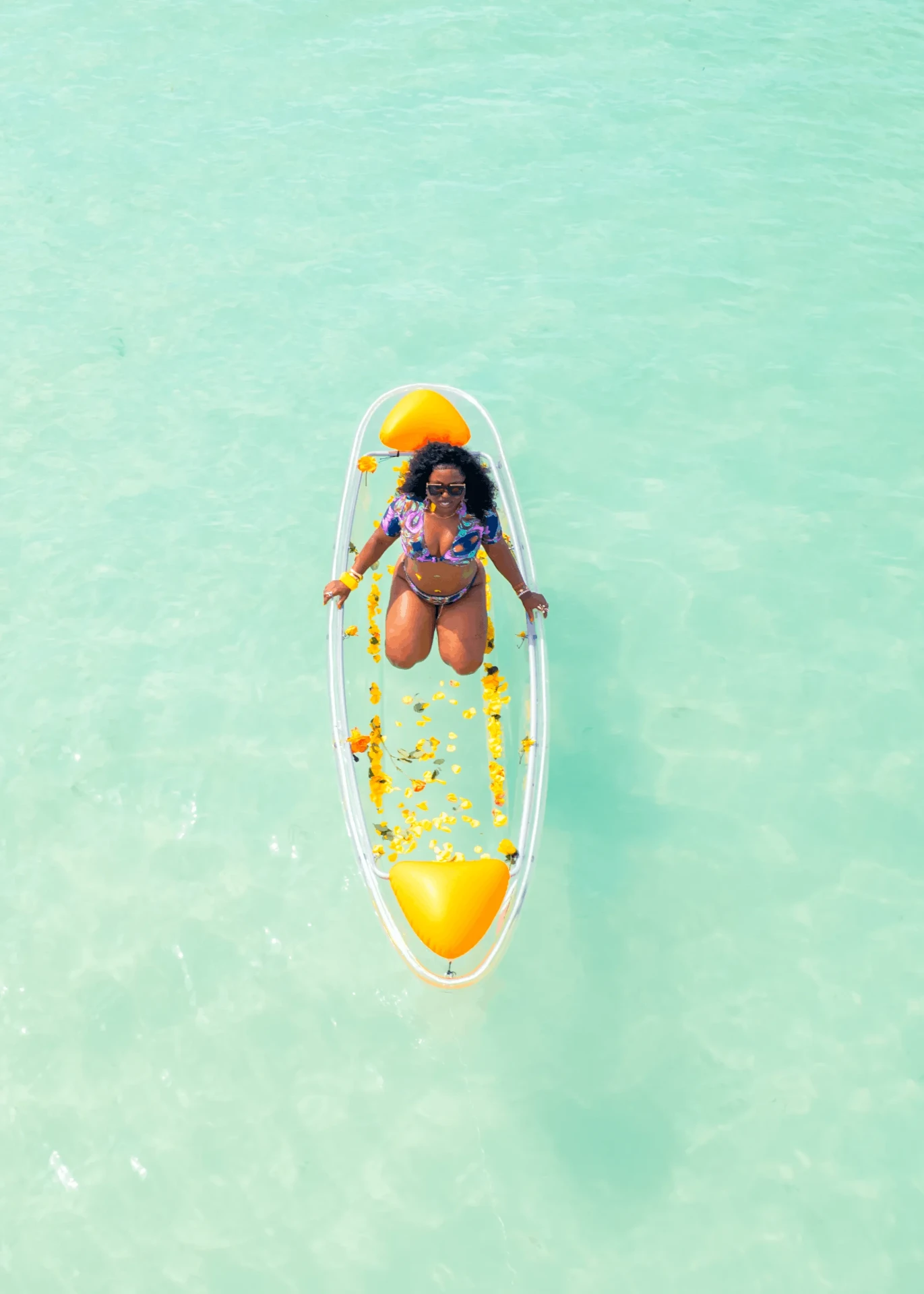 Top-down drone shot on glassy turquoise water, kayak photography in Zanzibar