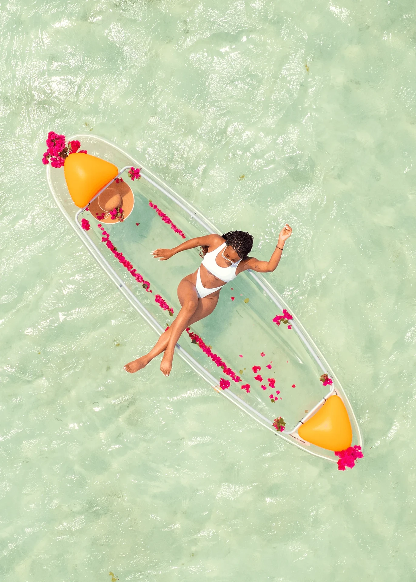 Drone shot of a clear kayak on pale green shallows, kayak photography in Zanzibar