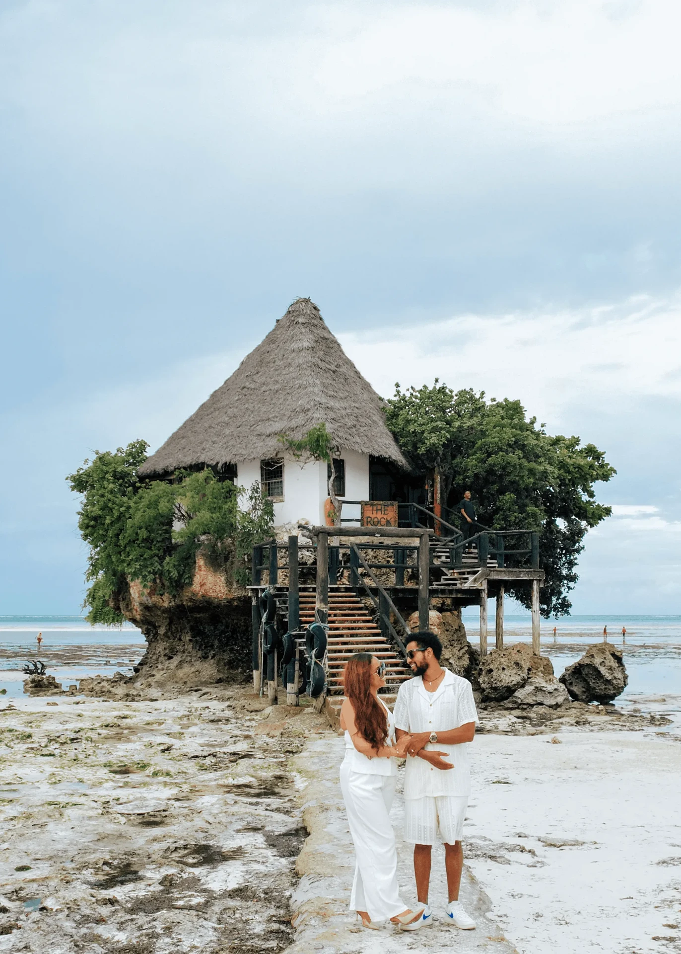 Holding hands in front of The Rock restaurant, couple photoshoot in Zanzibar