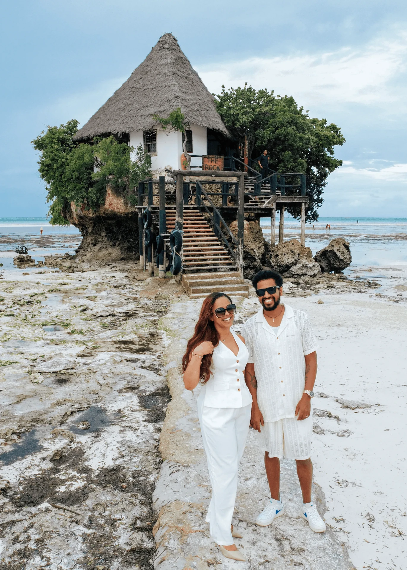 Dressed in white on the reef path to The Rock, couple photoshoot in Zanzibar