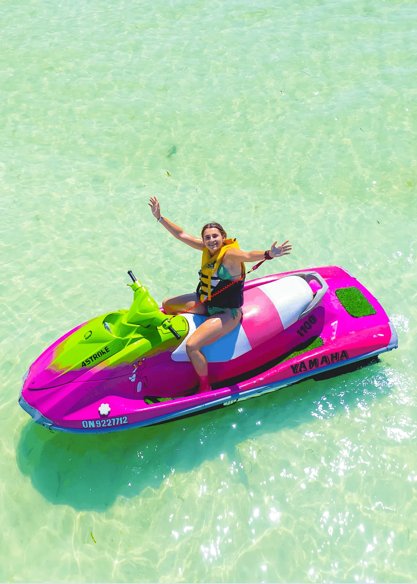 Drone shot waving from a pink and green jet ski, jet ski photography in Zanzibar