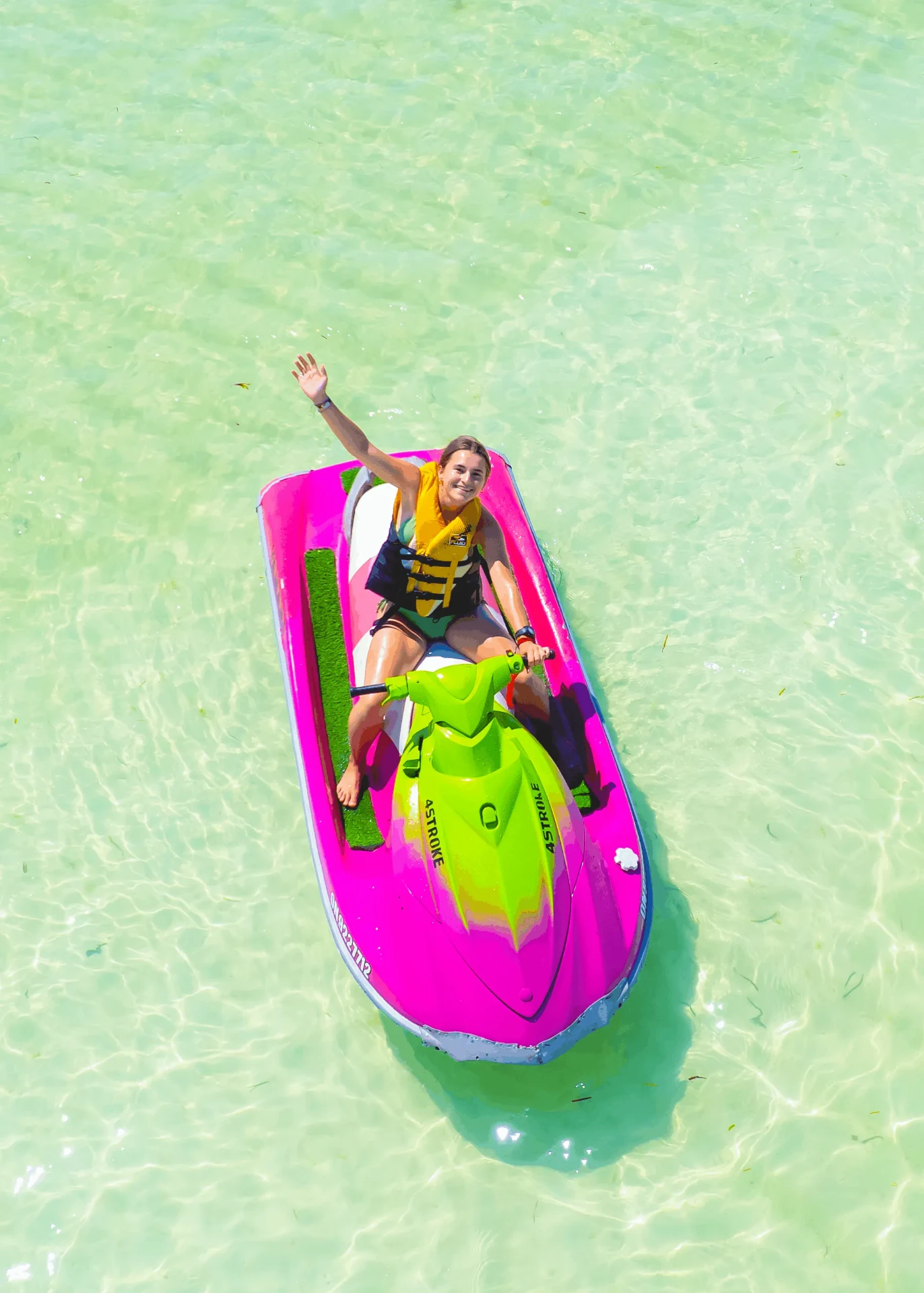 Overhead drone shot waving from a pink jet ski, jet ski photography in Zanzibar