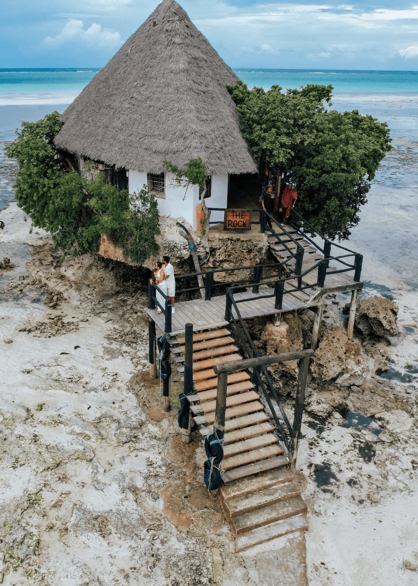 Drone shot of the couple on The Rock's deck, couple photoshoot in Zanzibar