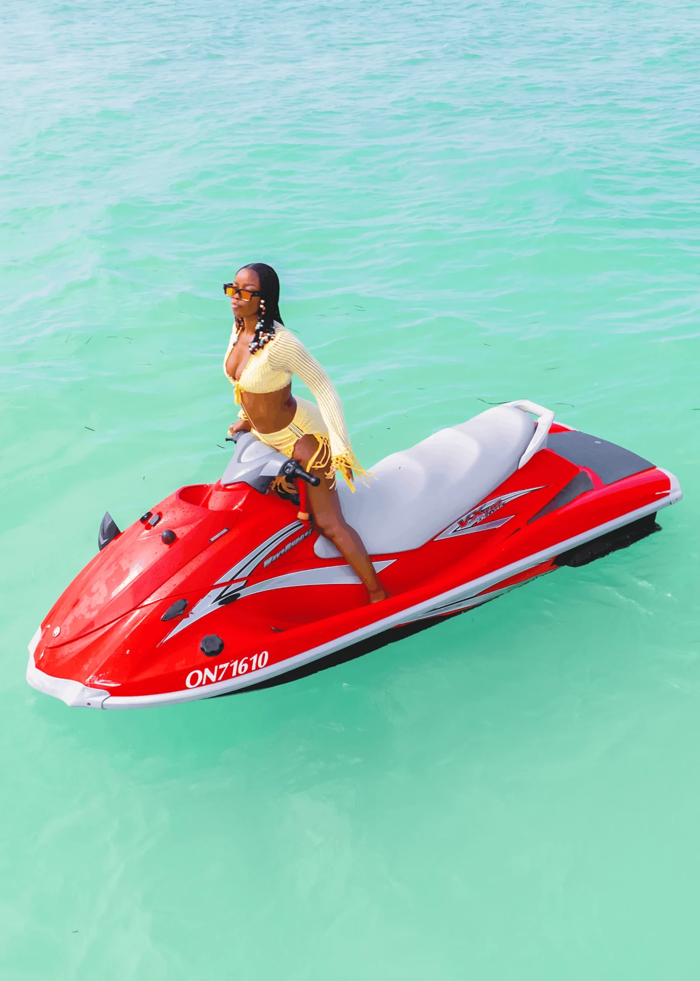 Portrait on a red jet ski over turquoise water, jet ski photography in Zanzibar