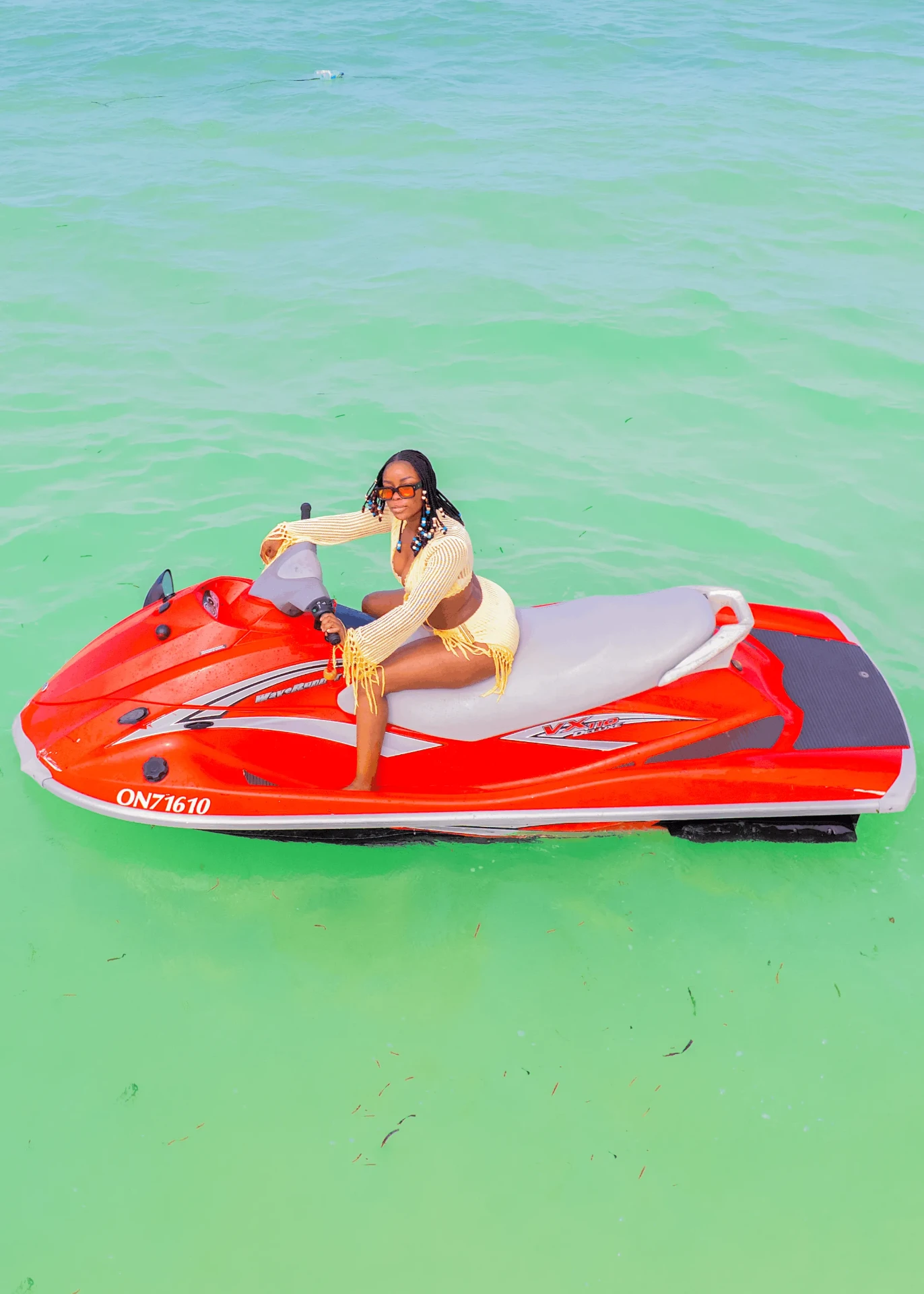 Side-on shot of a red jet ski in turquoise shallows, jet ski photography in Zanzibar