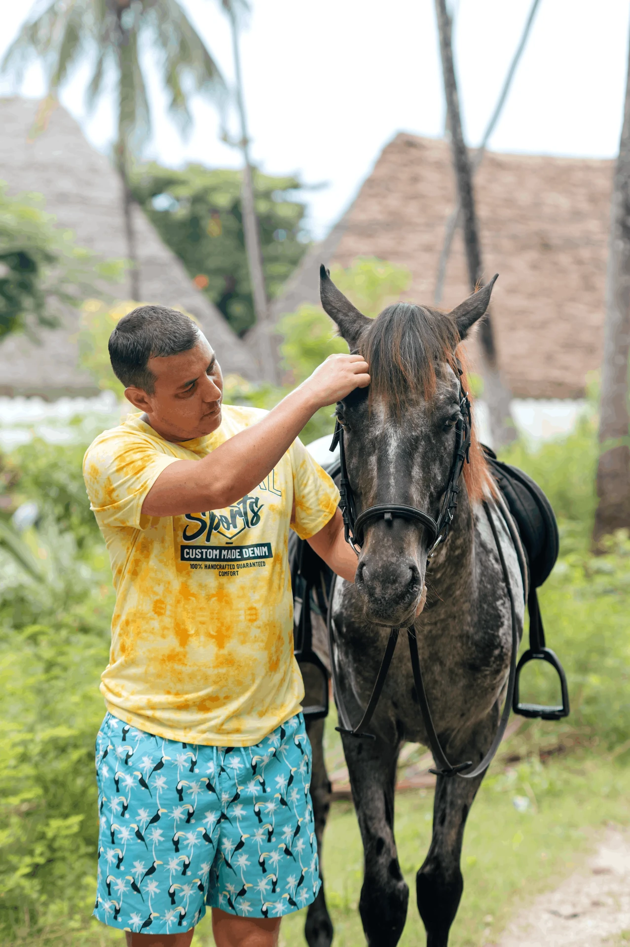 Rider greeting the horse before the session, horse riding photography in Zanzibar