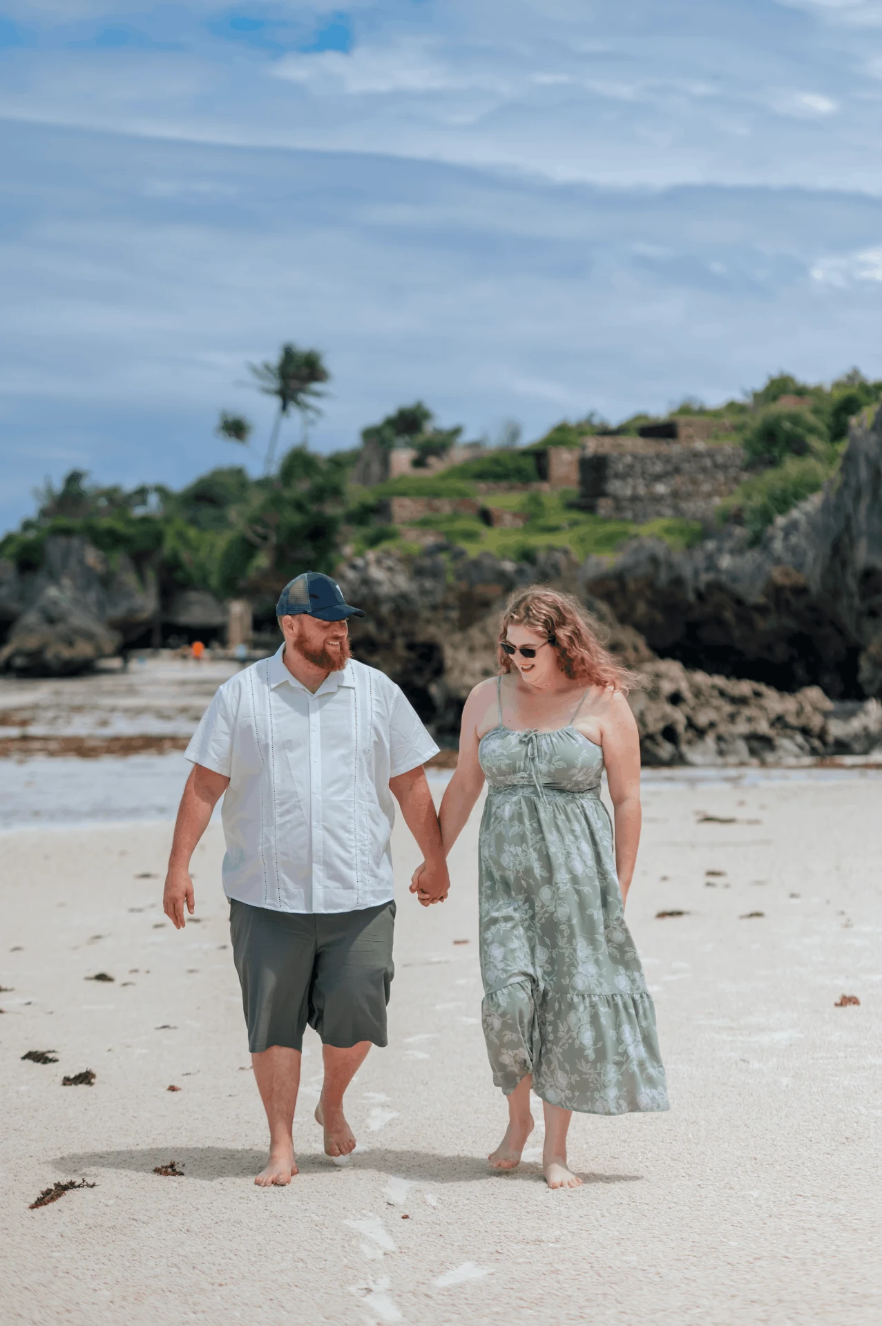 Walking hand in hand along the white sand beach, couple photoshoot in Zanzibar