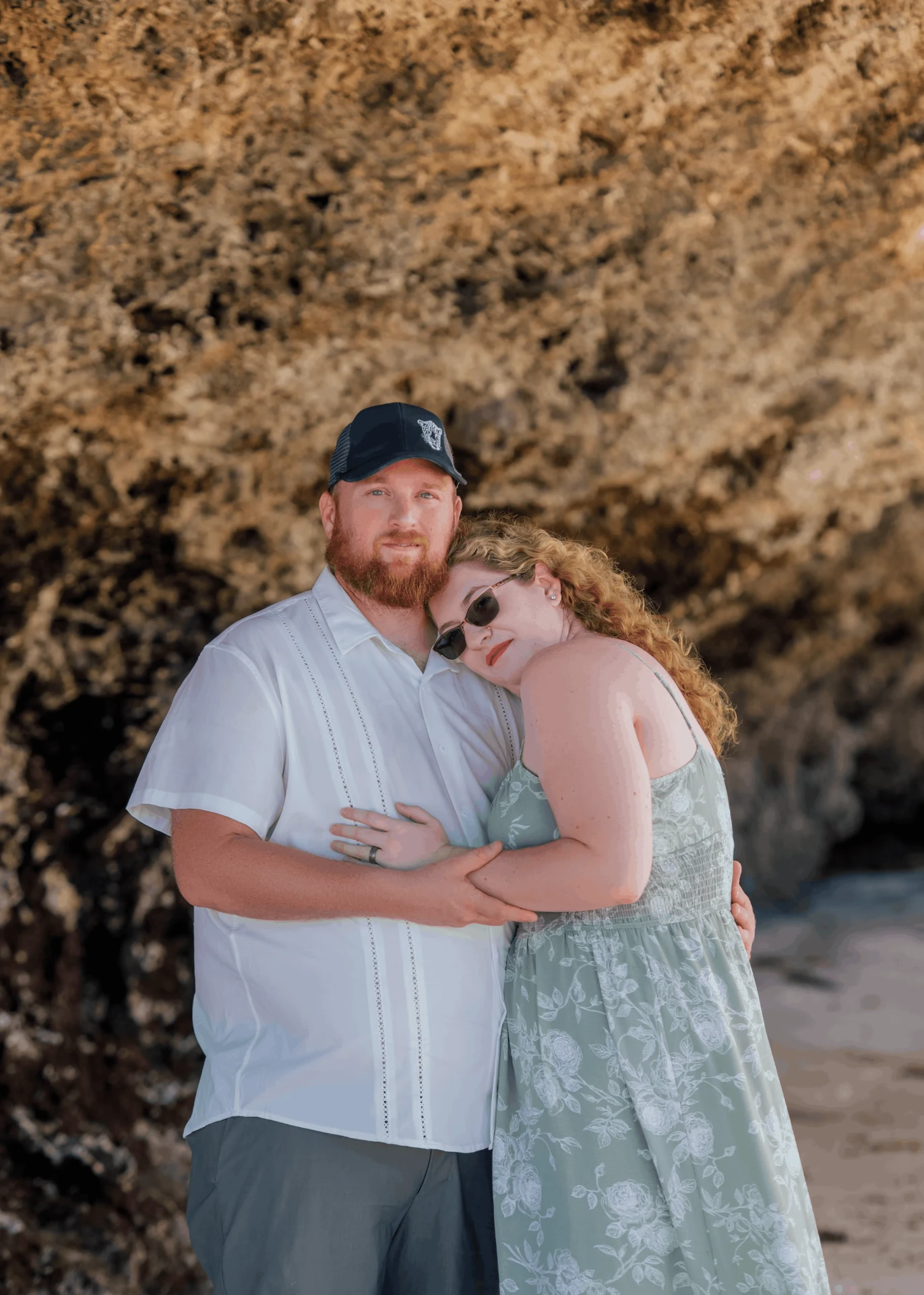 Embracing against a golden coral rock wall, couple photoshoot in Zanzibar