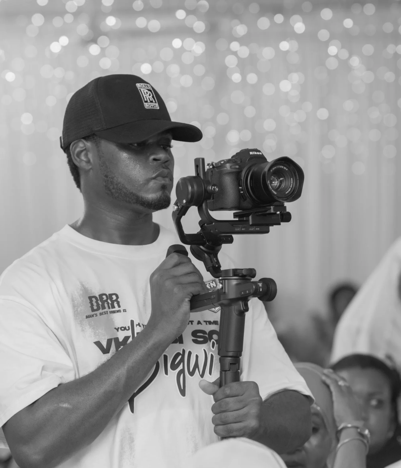 Mr Vibes photographer with Nikon camera and gimbal at a Zanzibar event
